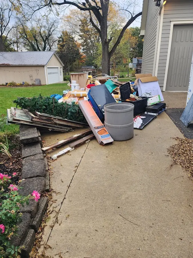 Dumpster being loaded with debris for Estate Cleanout Dumpster Rental in New Baltimore